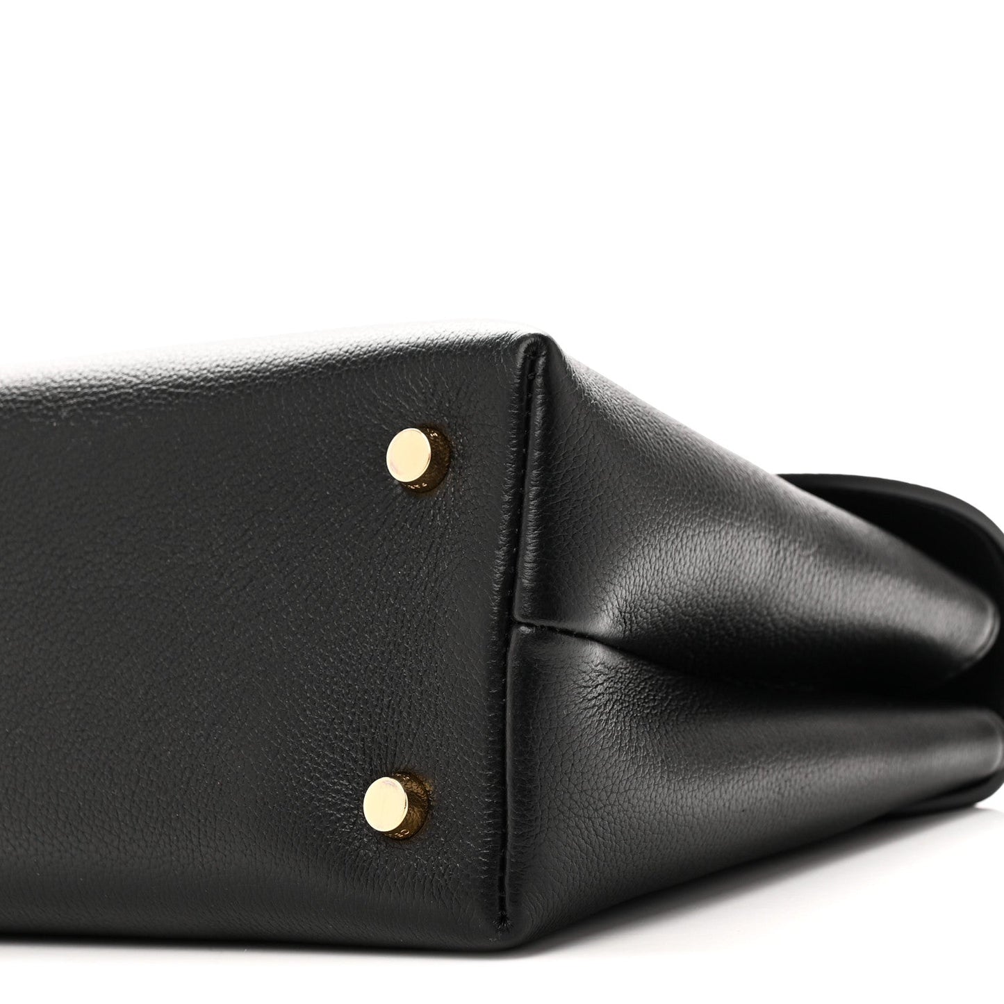 Black leather handbag corner with two gold studs and curved side panel