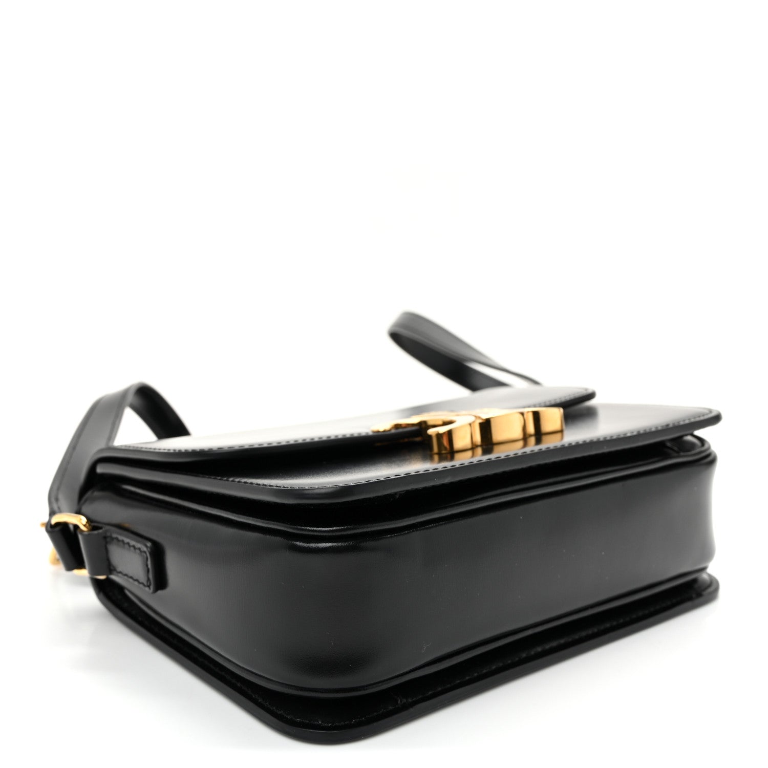 Black mini shoulder bag angled view with gold-tone hardware and structured flap.