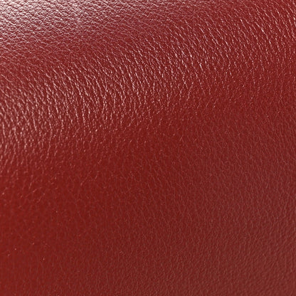 Light burgundy grained calfskin bag leather texture close-up