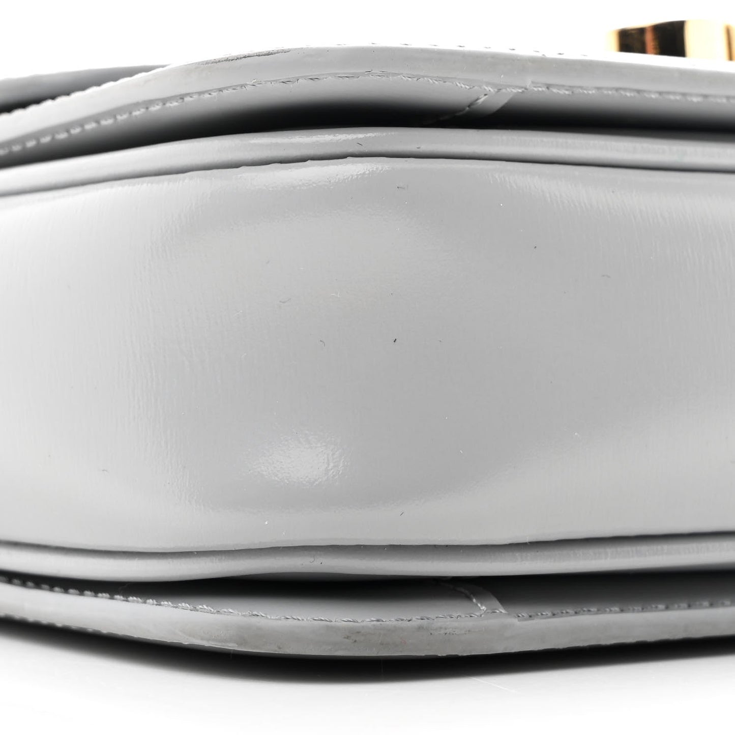 Shiny calfskin bag side panel close-up with stitched edge