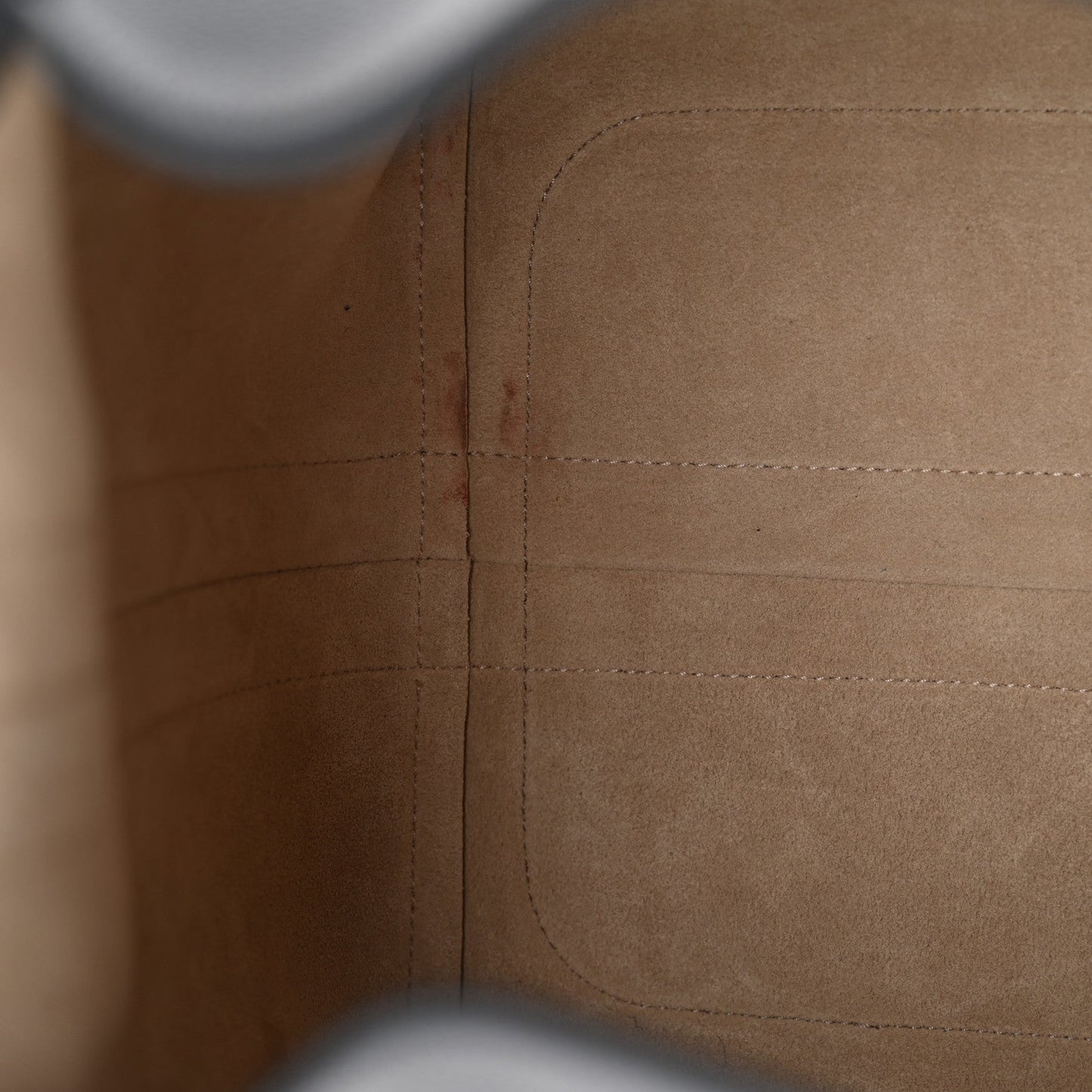 Tan interior lining close-up with stitched panels and reinforced seam lines