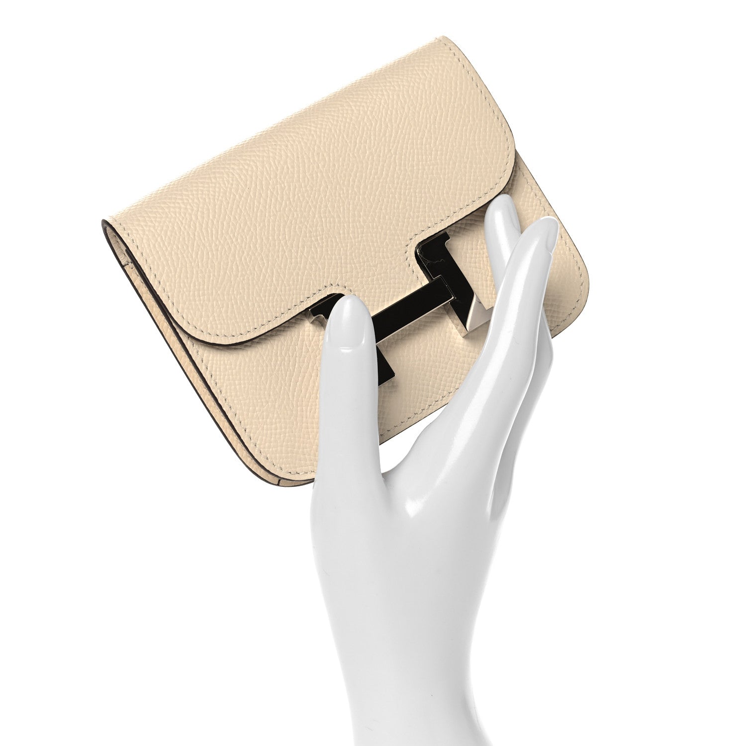 Slim Constance wallet in Nata textured leather with front clasp, angled view