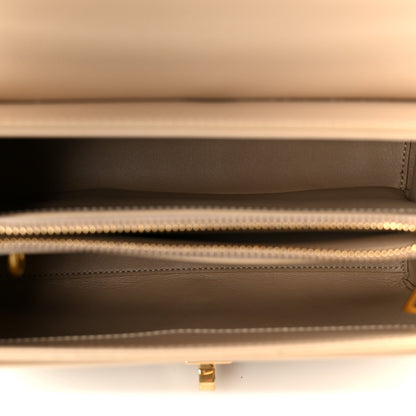 Nude leather bag interior with satin lining and zipper opening with gold trim
