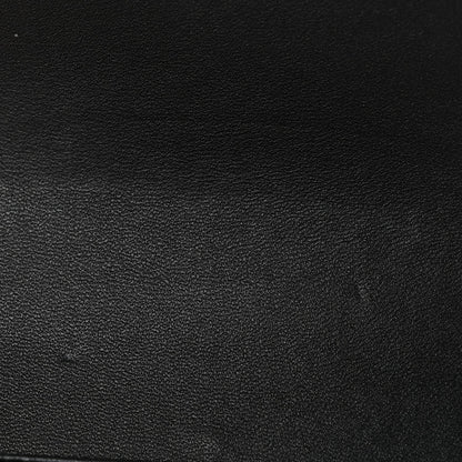 Black shiny calfskin leather texture close-up