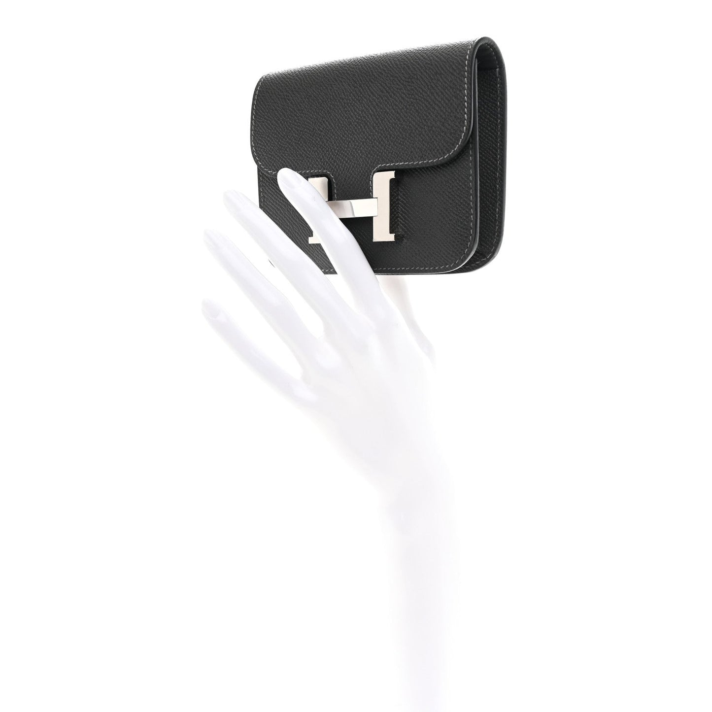 Constance slim wallet with H clasp in dark leather, angled side view