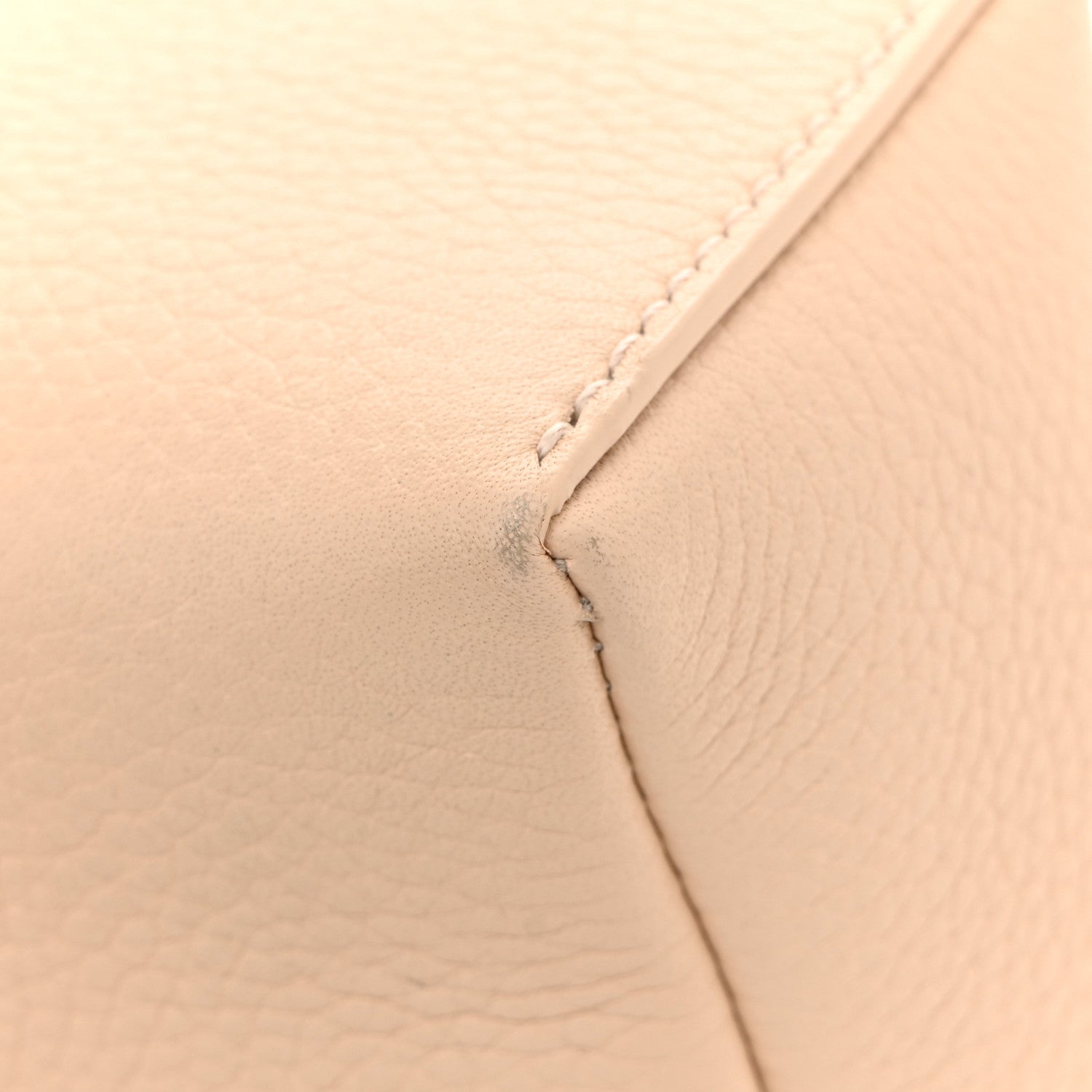 Cream leather pouch close-up of seam and stitching detail