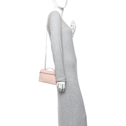 Light pink leather pouch with crossbody strap shown on model