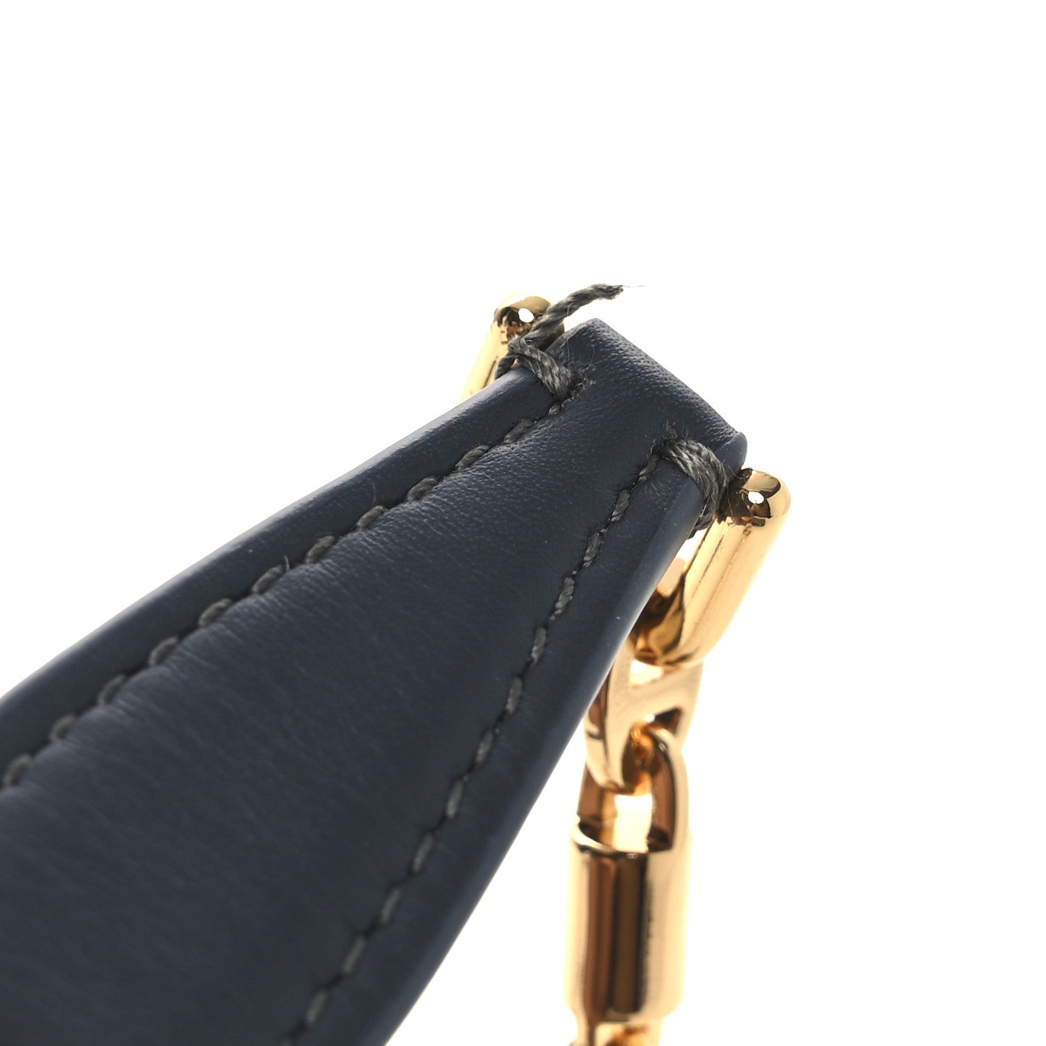 Mini pouch top corner with navy leather loop and gold clasp hardware