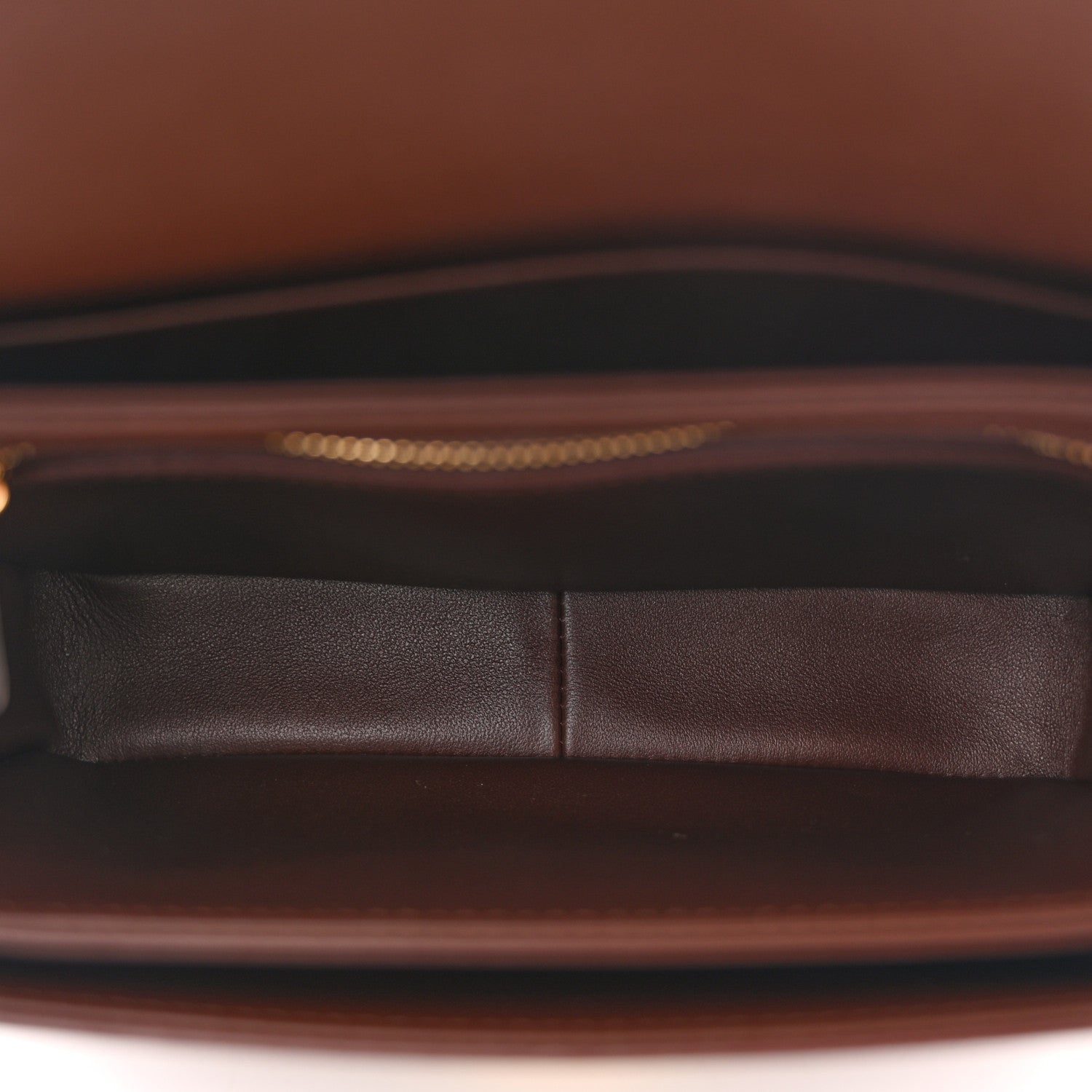 Chestnut leather interior lining with seam detail and dark underside trim