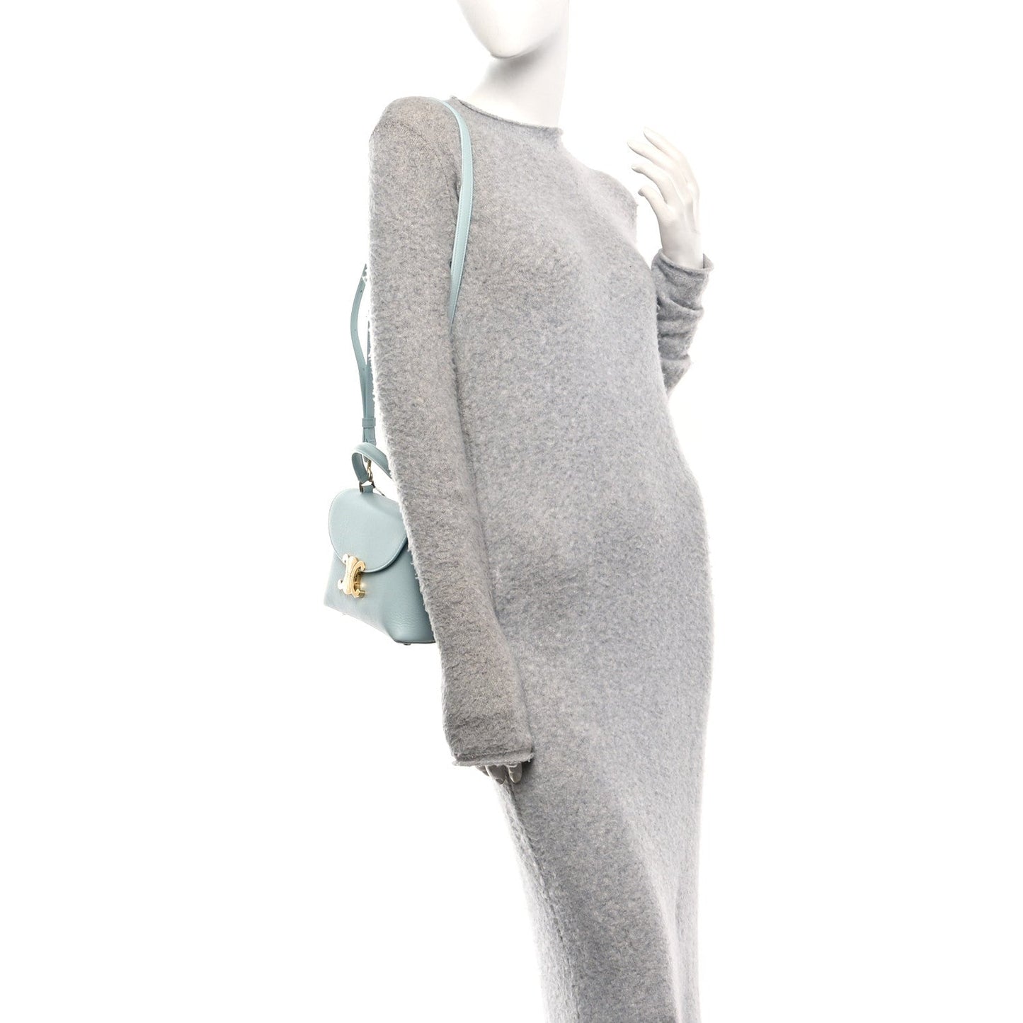 Light blue leather crossbody bag on mannequin with front flap and strap