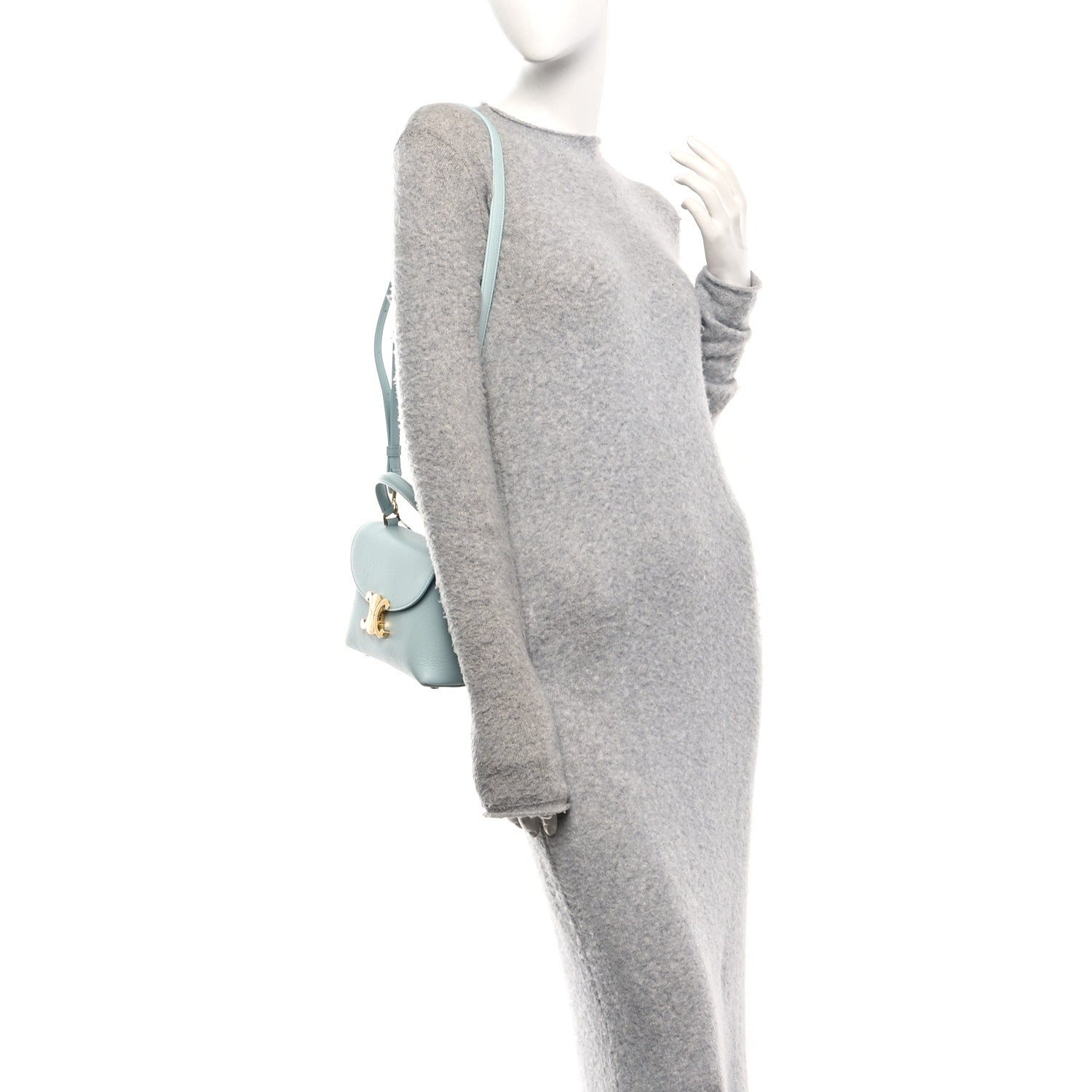 Light blue leather crossbody bag on mannequin with front flap and strap