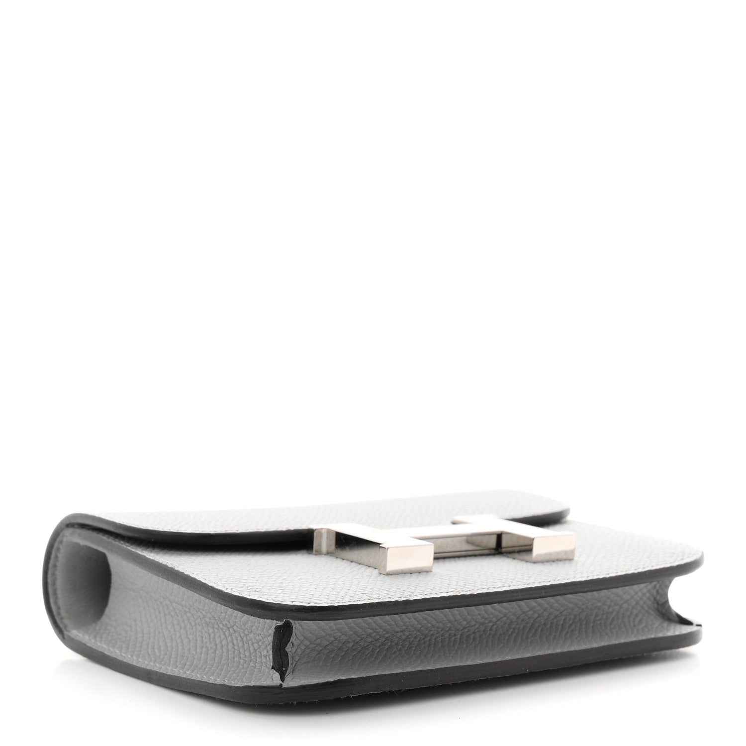 Hermes Constance slim wallet underside, light blue textured leather with stitched edge.