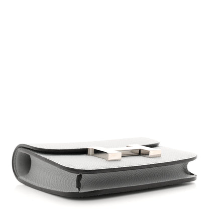Hermes Constance slim wallet underside, light blue textured leather with stitched edge.