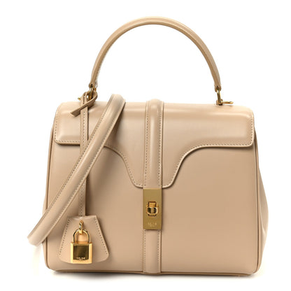 Small nude calfskin top-handle bag with flap, crossbody strap, and gold-tone hardware