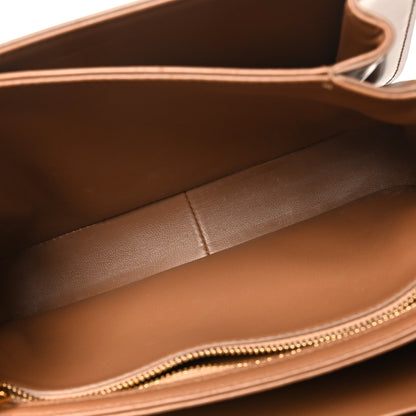 Bronze leather bag interior with stitched lining and gold-tone zipper opening