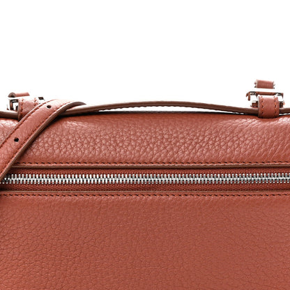 Top view of grained calfskin pouch with zip, leather handle loops, and buckles