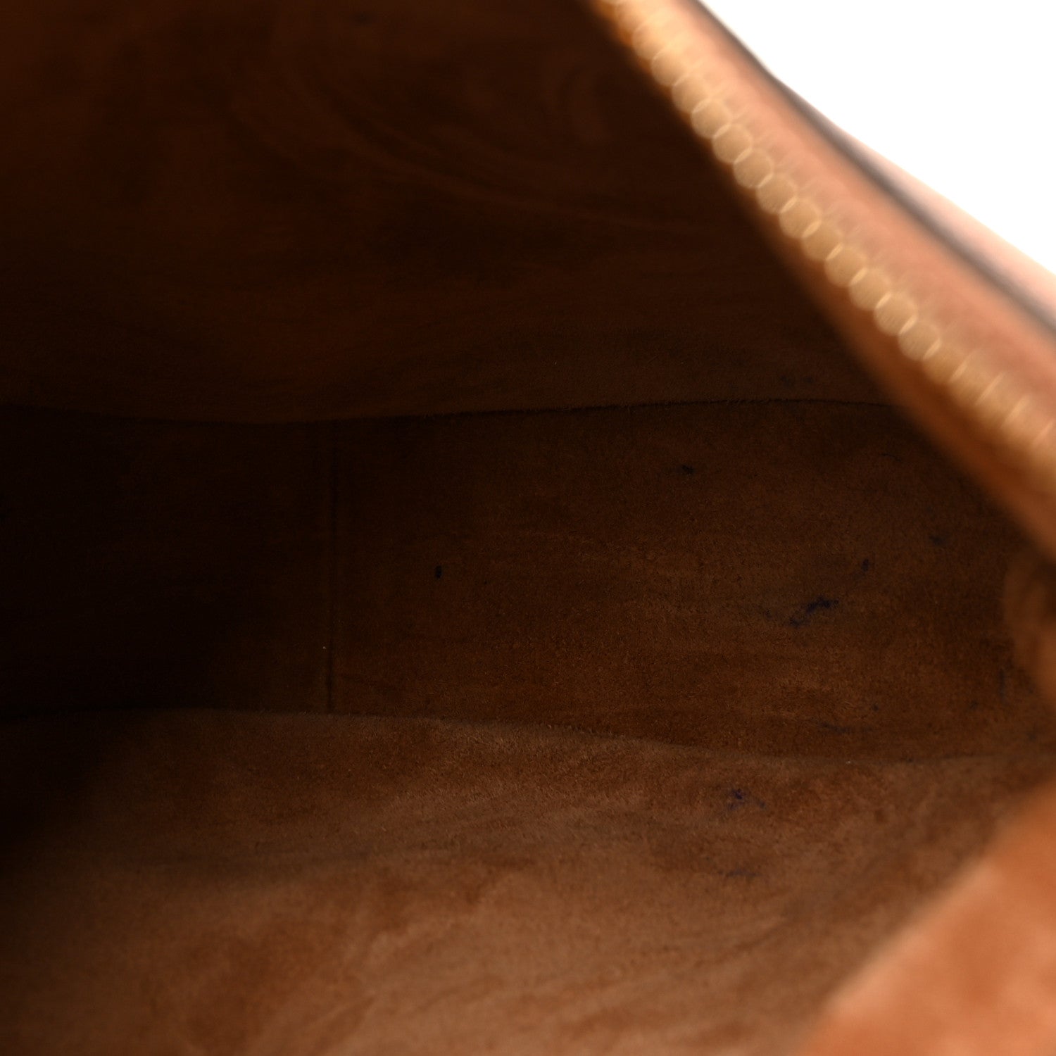 Tan leather interior lining close-up inside a hobo shoulder bag