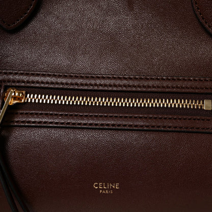 Celine lambskin handbag front zipper with gold-toned pull and stitched leather edge