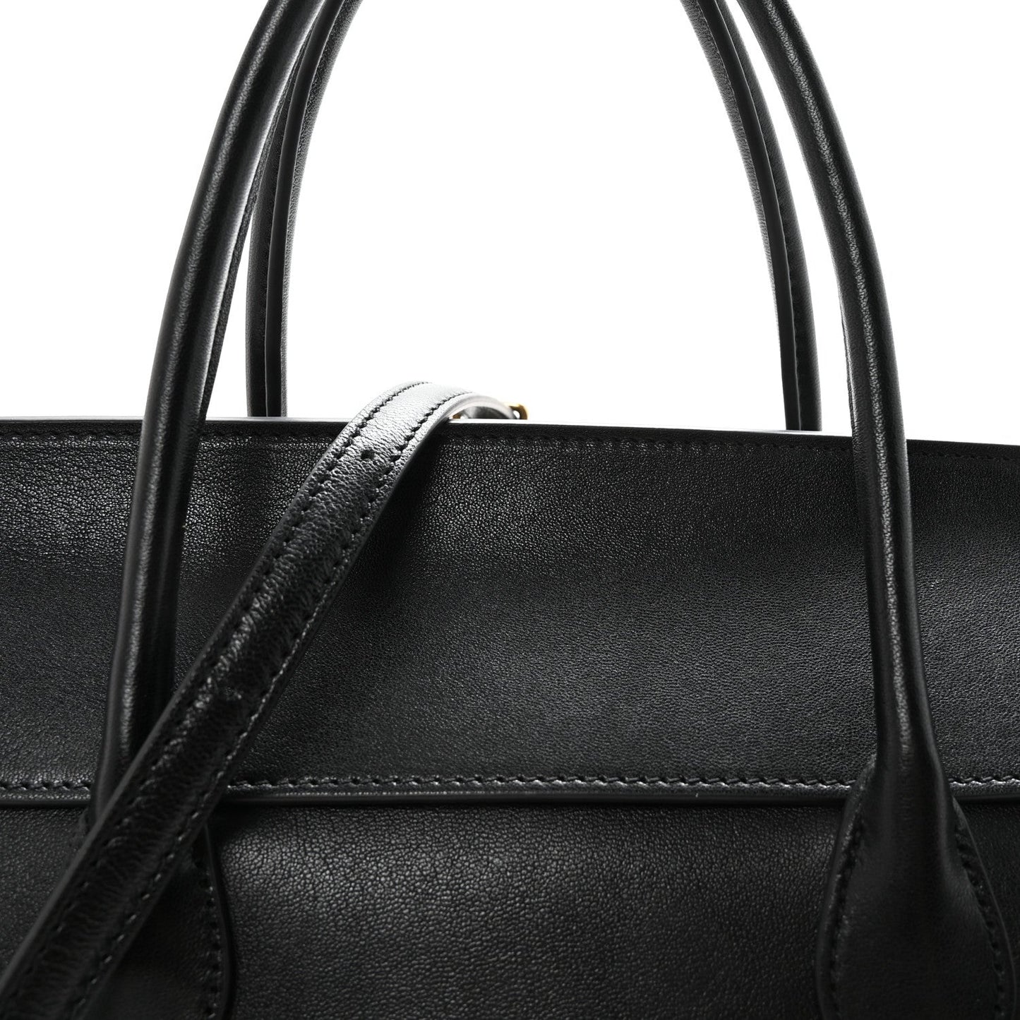 Black leather bag top handle with reinforced stitching detail.
