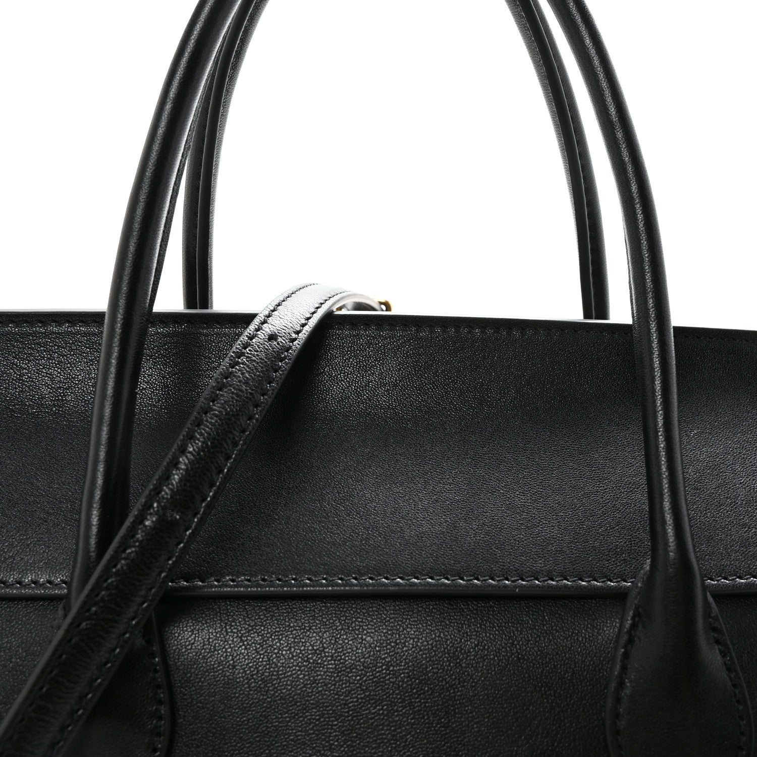 Black leather bag top handle with reinforced stitching detail.