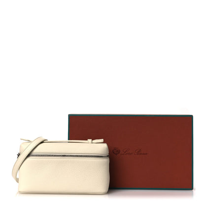 White grained calfskin pouch with zip, positioned beside brand gift box
