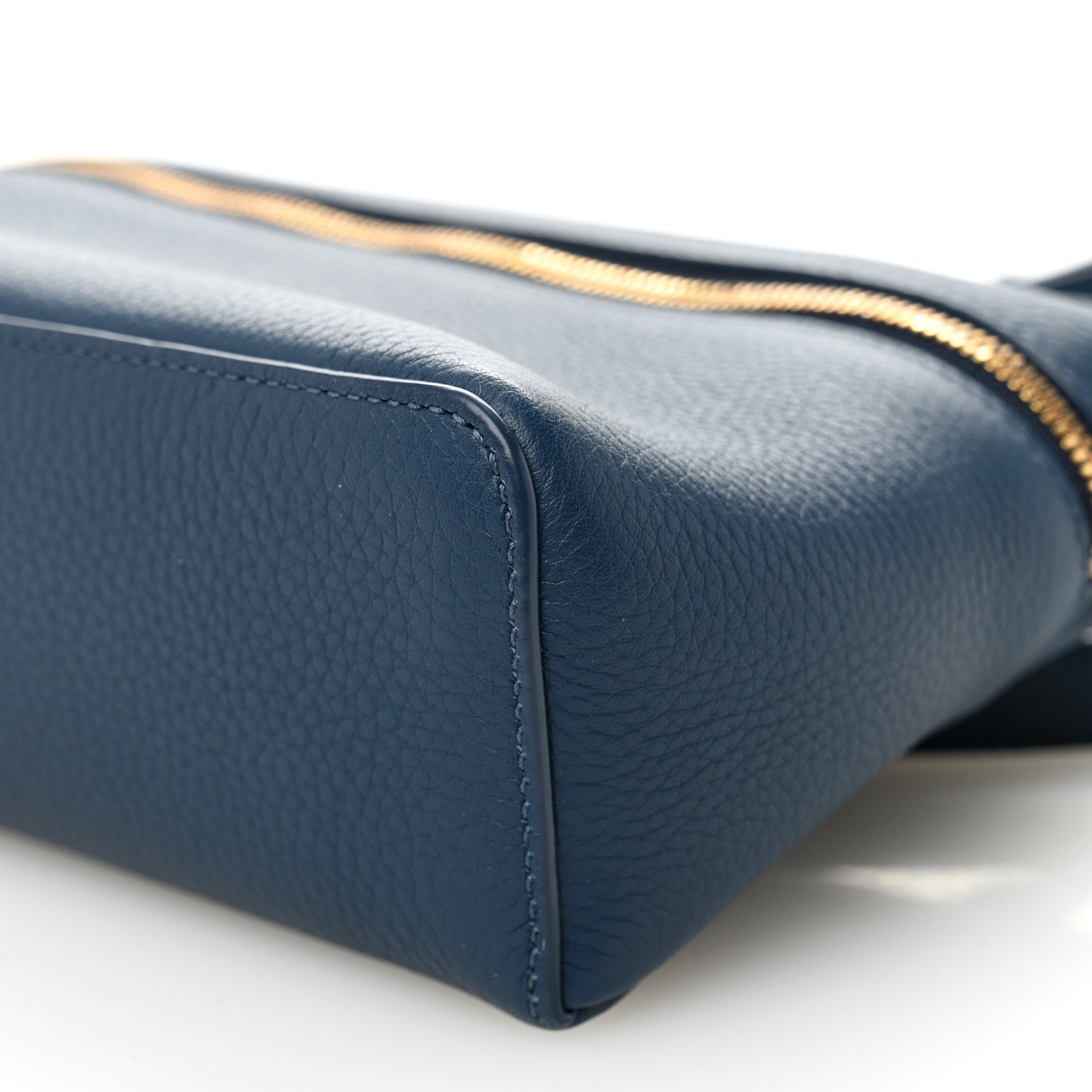 Navy grained calfskin pouch base corner with gold zipper trim