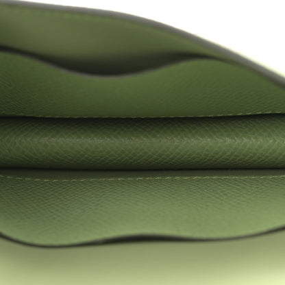 Light green leather wallet interior close-up with curved seam
