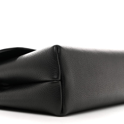 Black leather shoulder bag corner close-up showing seam and curved base