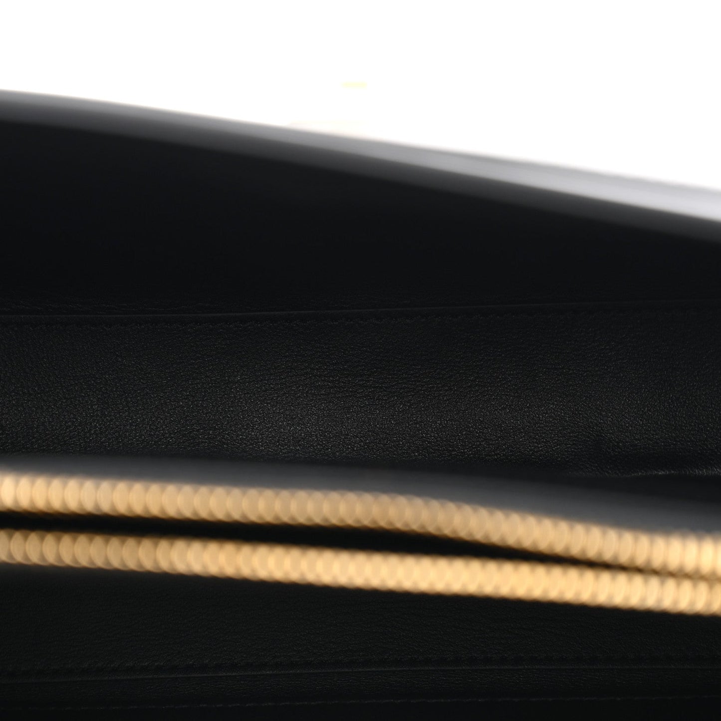 Black leather base with fine grain texture and gold trim edge