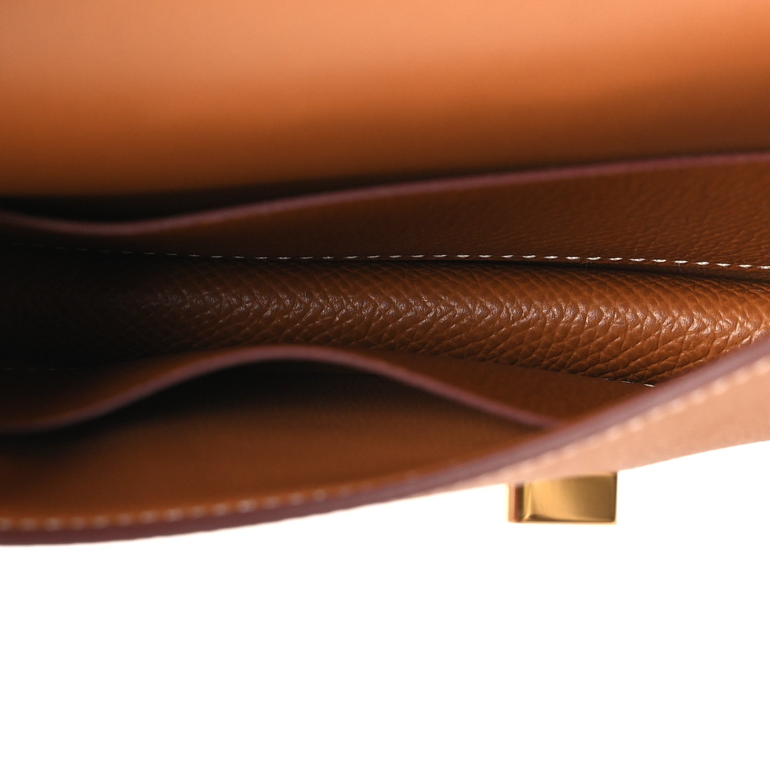 Constance slim wallet close-up of tan leather edge stitching with gold-tone hardware
