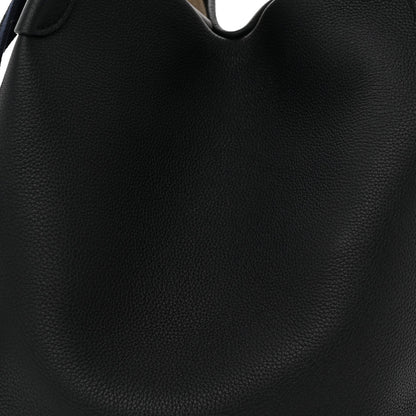 Grained dark navy leather exterior close-up with curved opening and seam