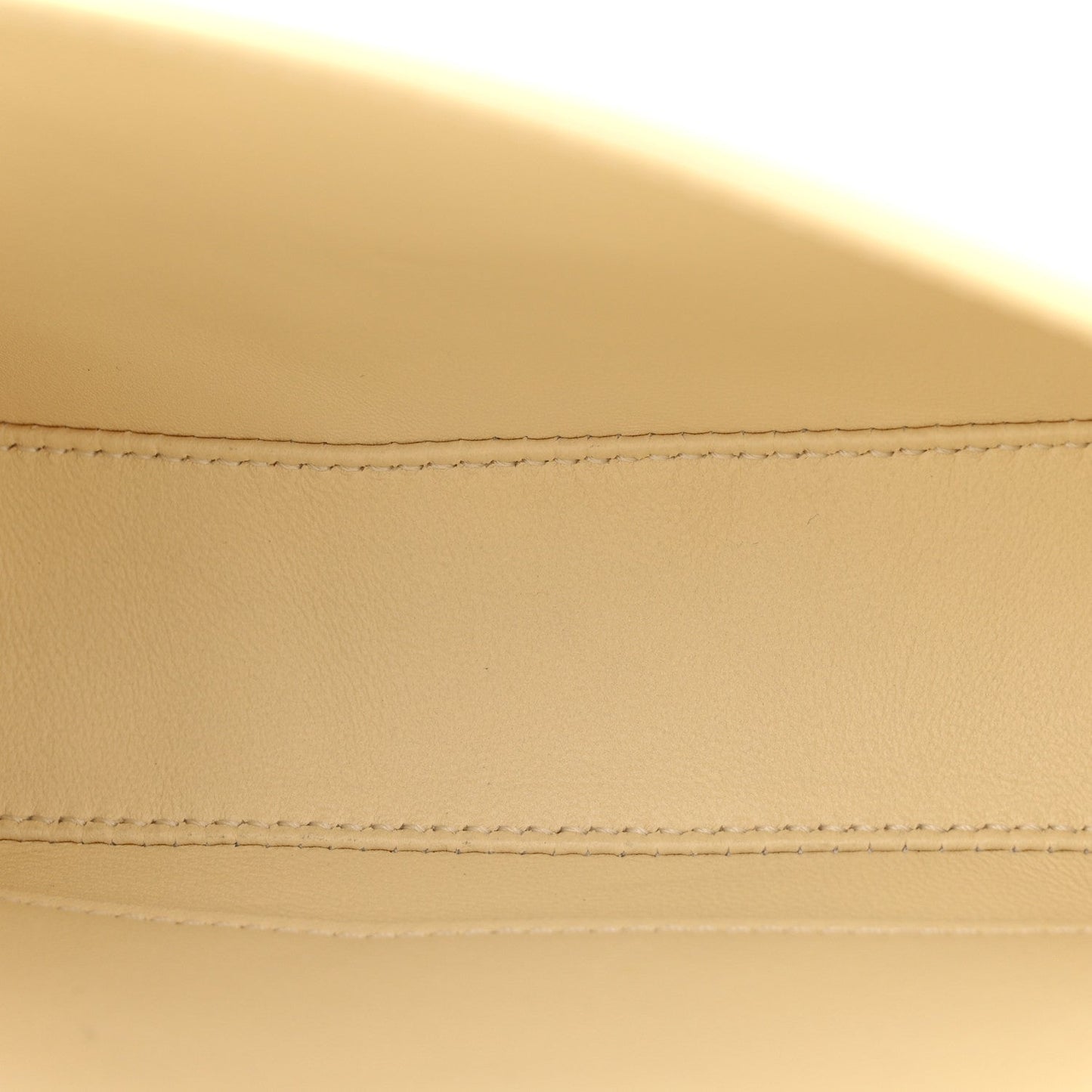 Close-up of nude calfskin flap stitching and neat seam detail
