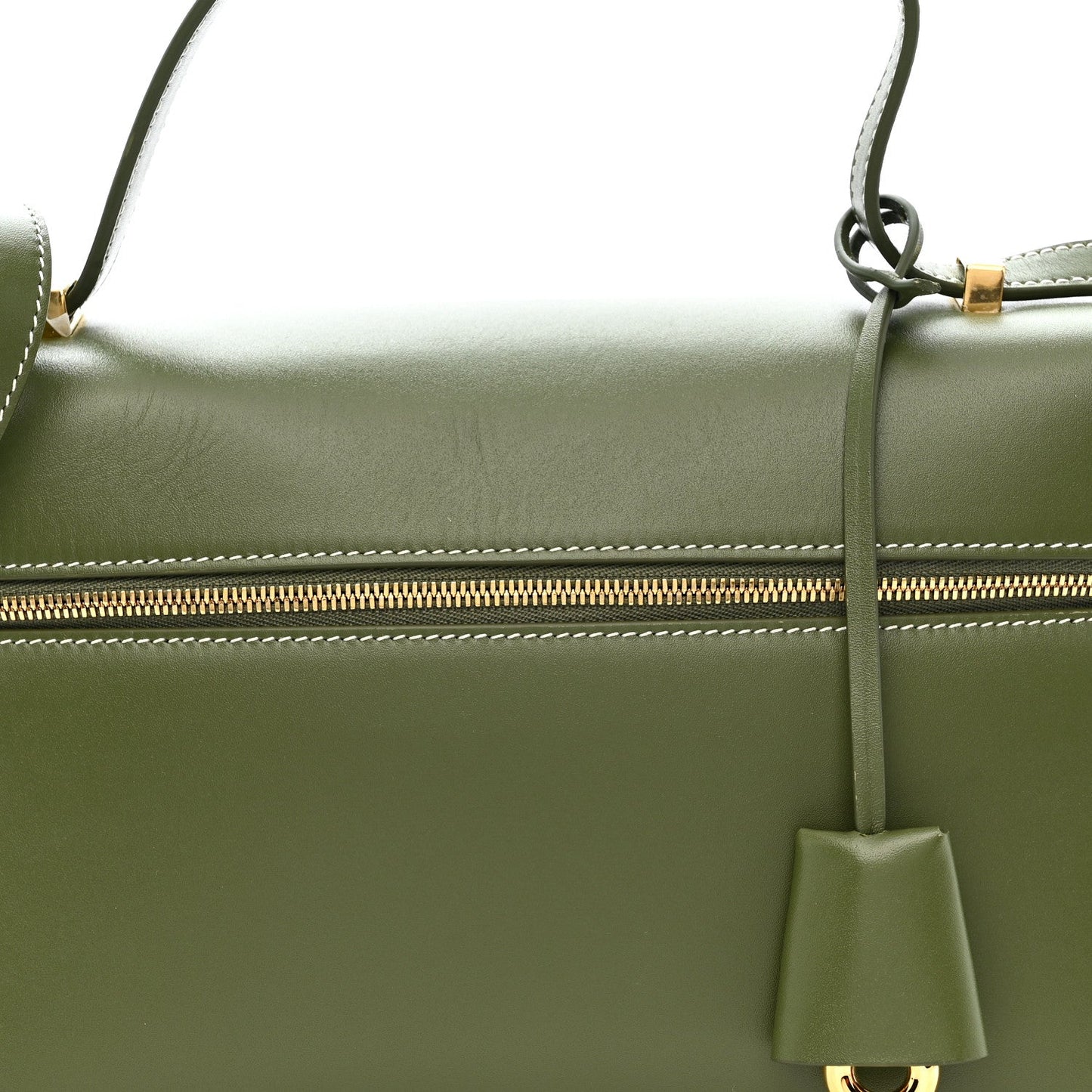 Olive green leather handbag with gold zipper track and hanging leather tassel charm