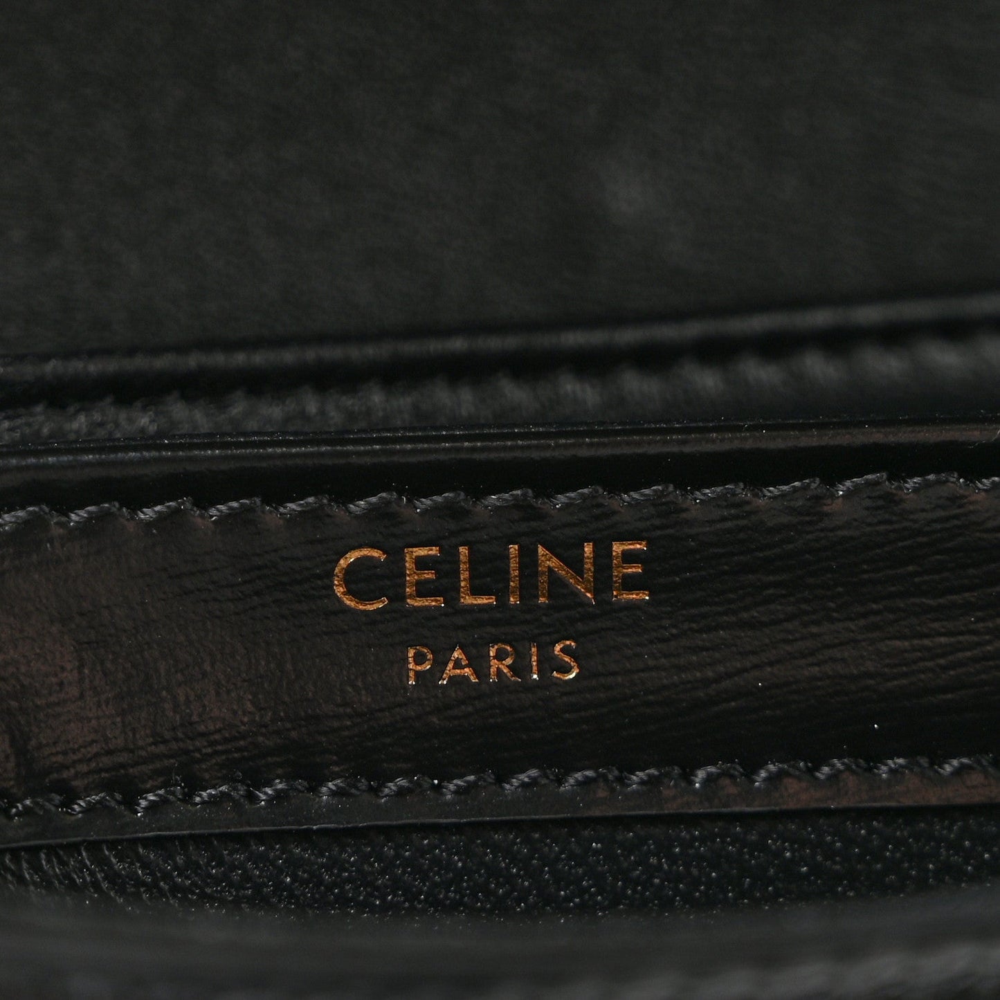Black leather mini crossbody bag with gold-tone “CELINE PARIS” logo stamp