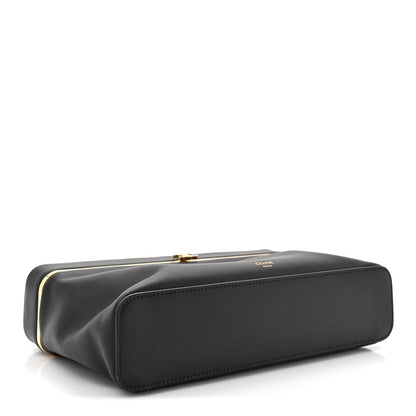 Black leather rectangle bag side view with gold-tone top clasp hardware