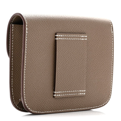 Taupe slim wallet with open view showing textured leather and white stitching