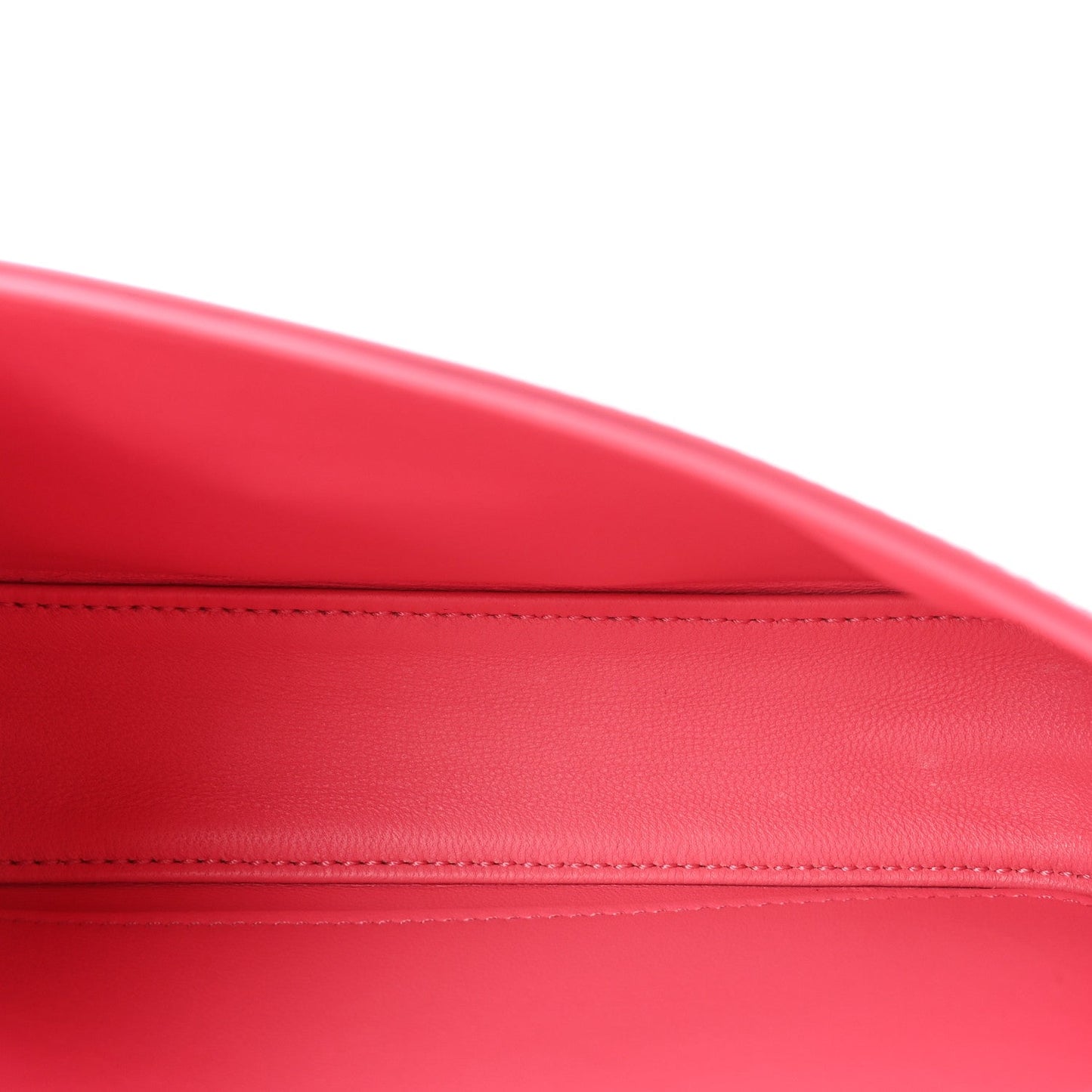Flamingo pink leather surface with contrast-stitched edge seam