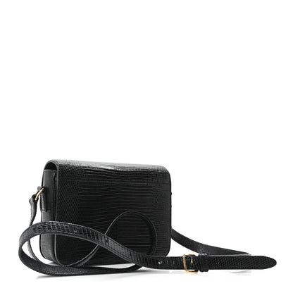 Black lizard-embossed crossbody flap bag with gold clasp and adjustable strap