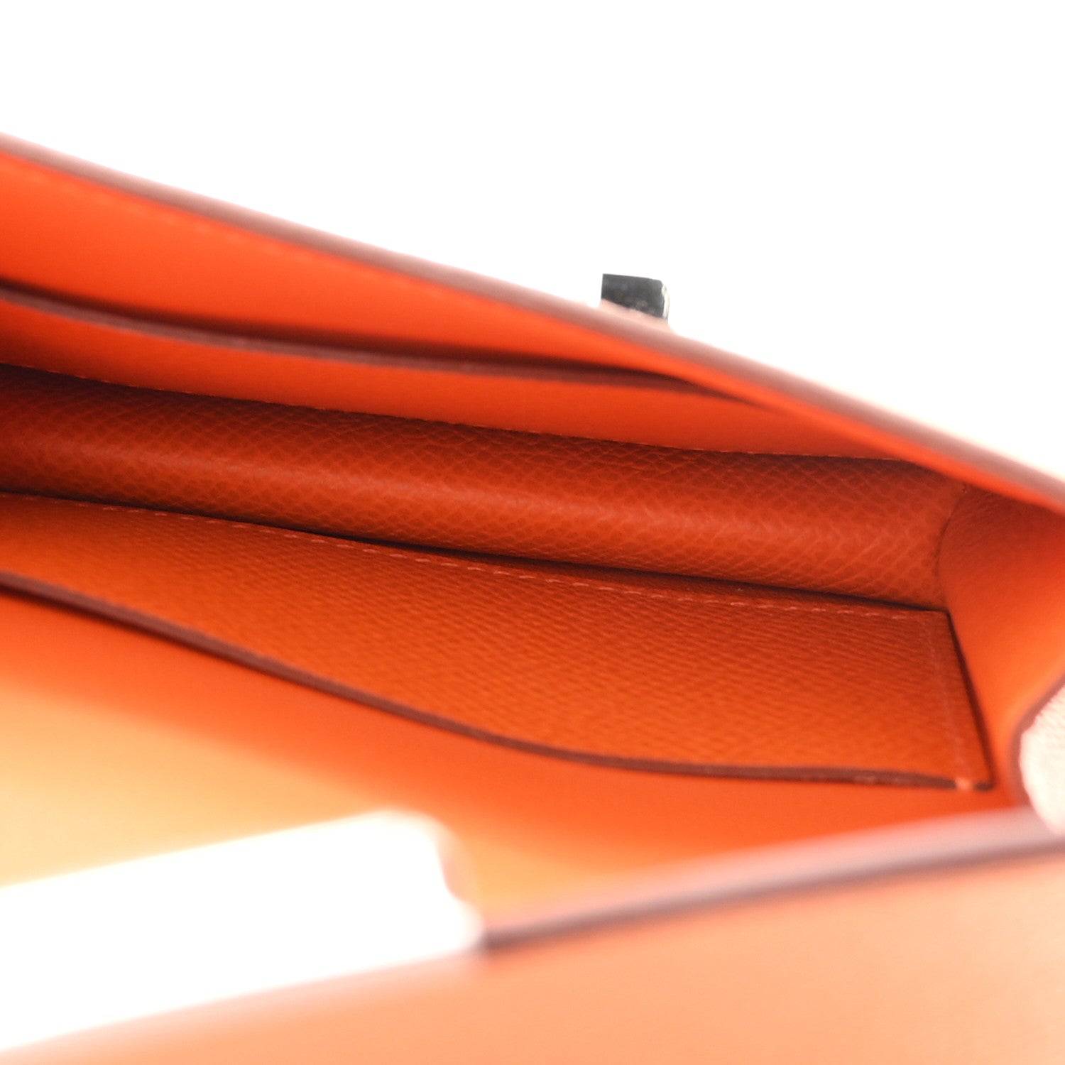 Orange Epsom leather slim wallet interior edge seam close-up.