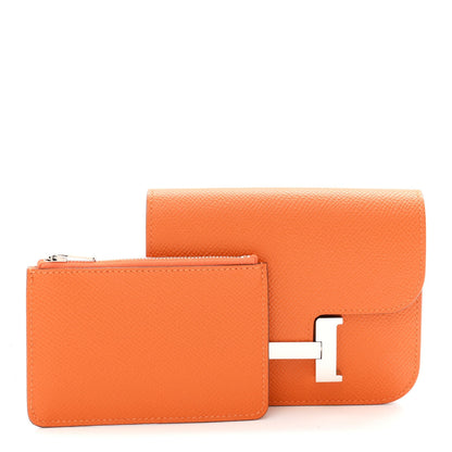Orange Epsom leather slim wallet with H clasp, side view.