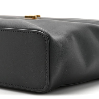 Black leather rectangle bag corner with curved seam and edge stitching