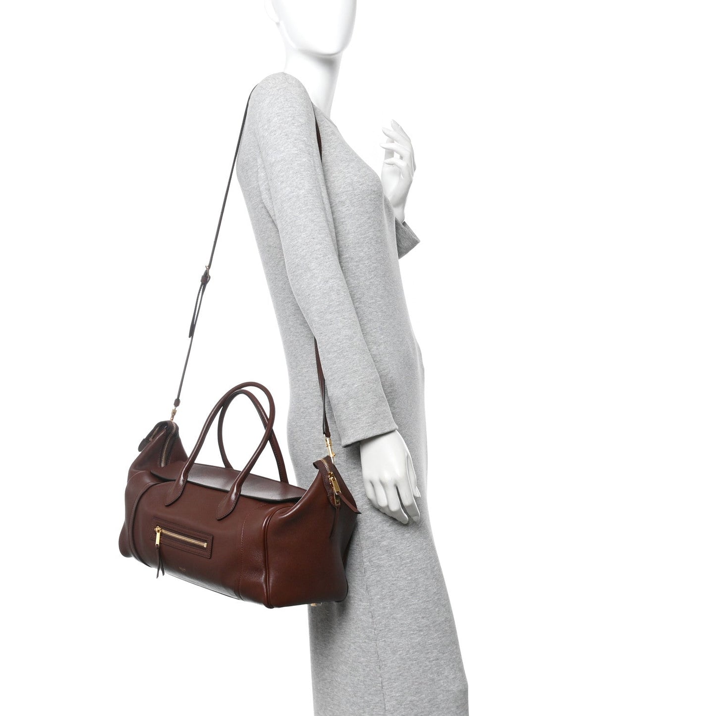 Dark brown lambskin handbag with top handles and long shoulder strap on mannequin