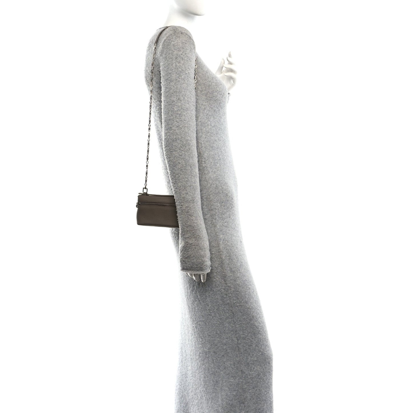 Small grained leather crossbody pouch with chain strap and top zip, worn at side