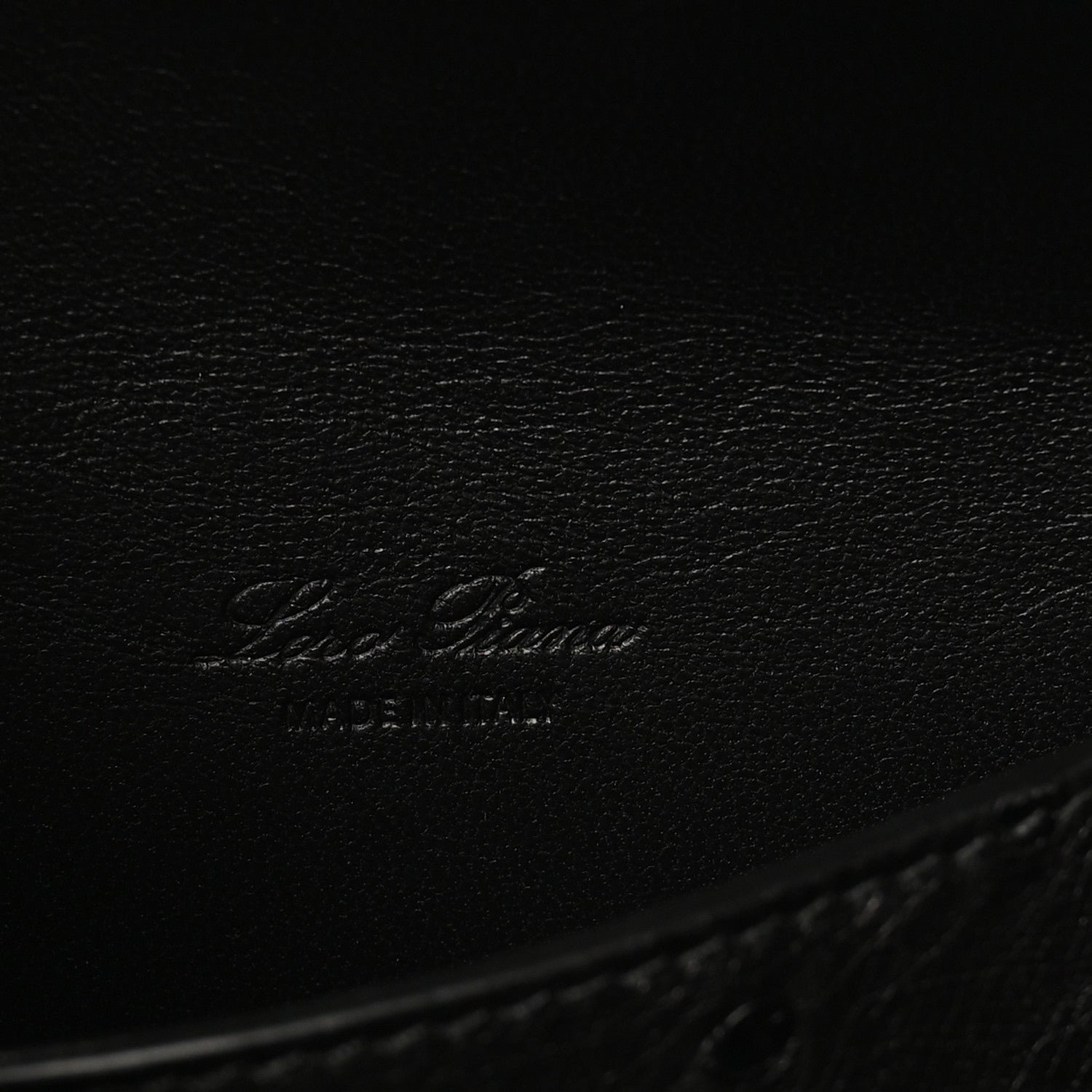 Black ostrich leather with embossed Loro Piana logo on inner base.