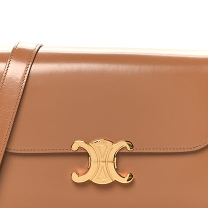 Bronze flap with gold-tone Triomphe emblem and contrast edge stitching