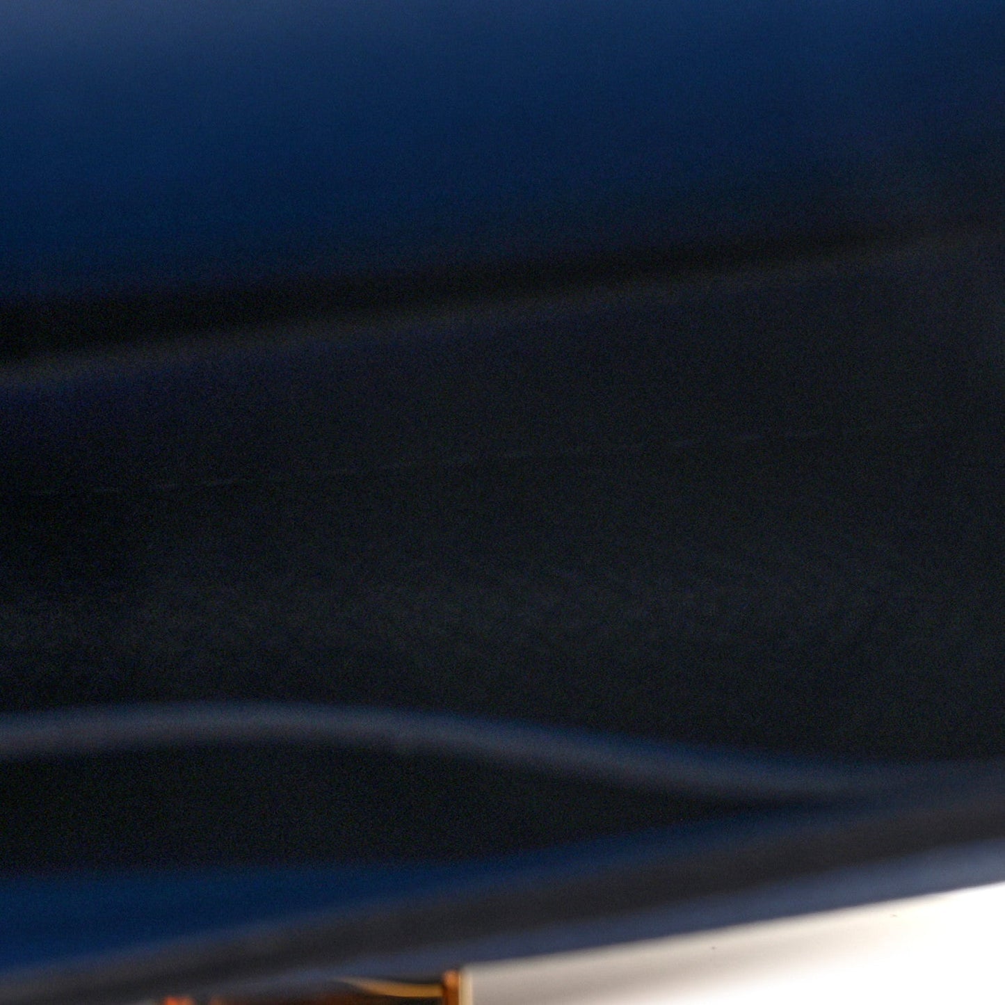 Blue leather wallet close-up of cover edge and smooth surface
