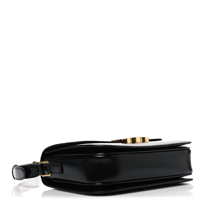 Shiny calfskin medium shoulder bag, black base side view with gold-tone hardware