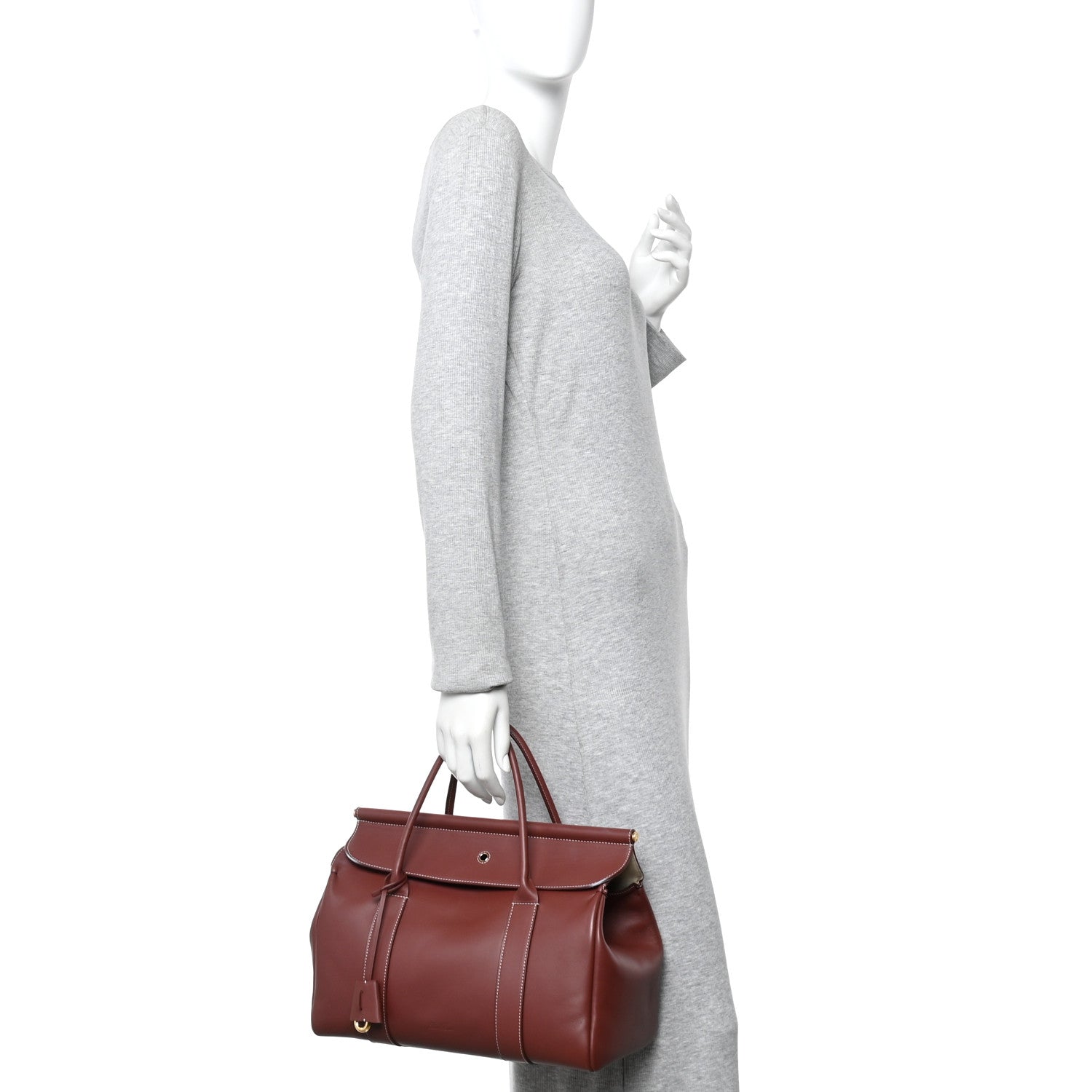 Loro Piana calfskin loom bag carried at side, dark brown with snap flap